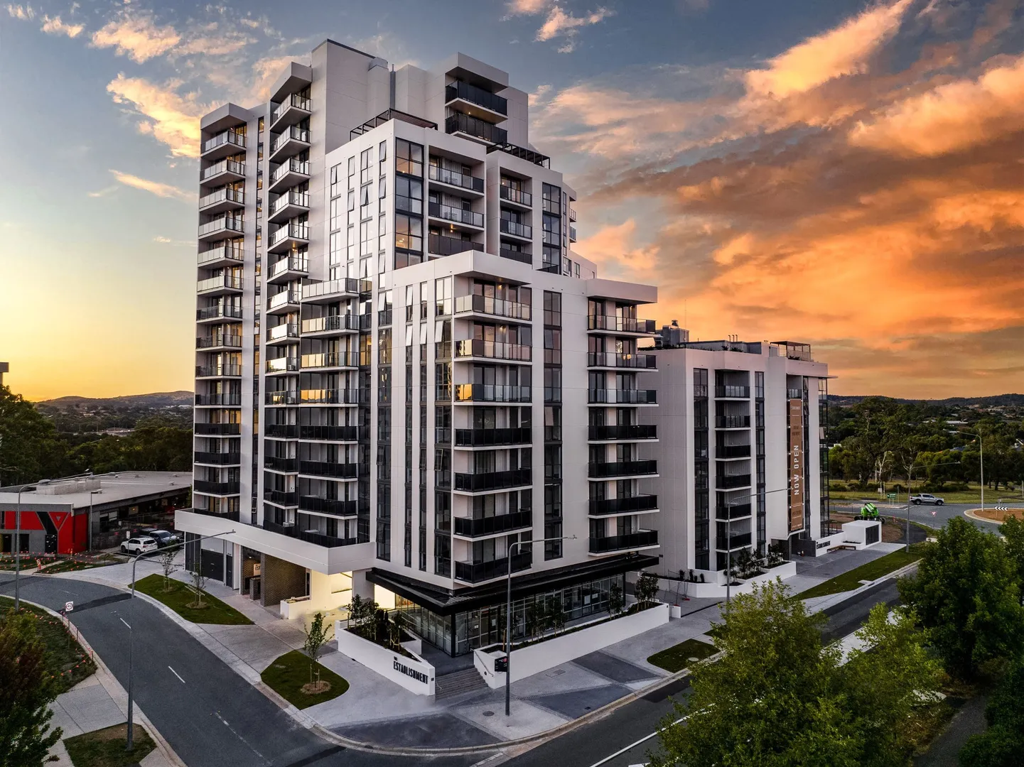 Modern apartment buildings with sunset sky.