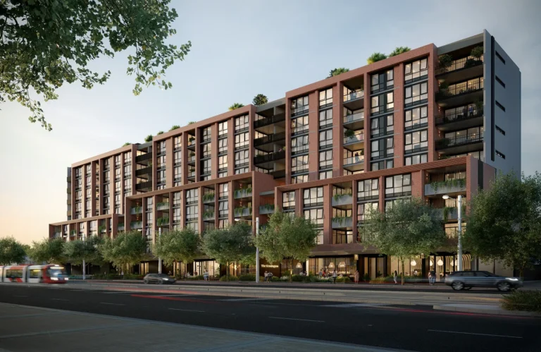 Modern apartment building with trees and cars