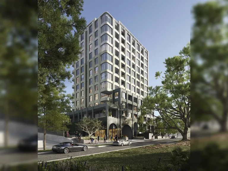 Modern apartment building with trees and street view.
