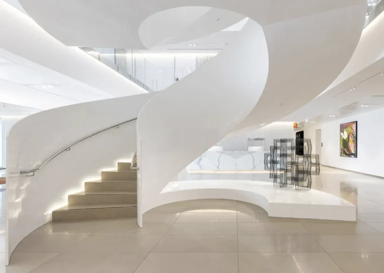 Spiral staircase in modern, white interior space.